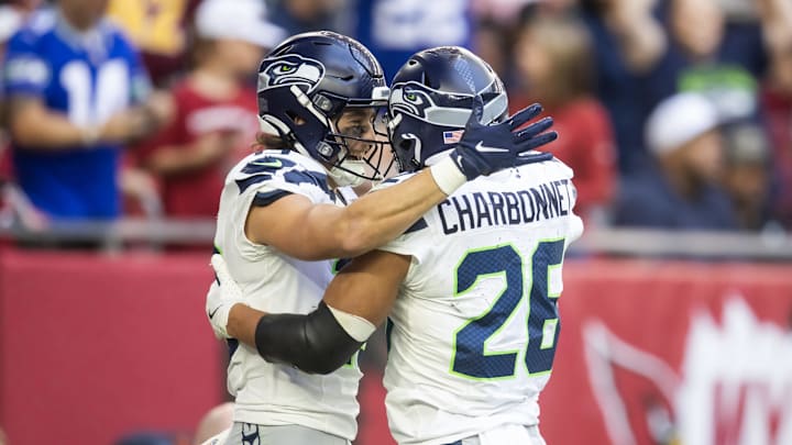 Dec 8, 2024; Glendale, Arizona, USA; Seattle Seahawks running back Zach Charbonnet (26) celebrates a touchdown with teammate Jake Bobo against the Arizona Cardinals in the first half at State Farm Stadium. Mandatory Credit: Mark J. Rebilas-Imagn Images