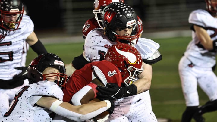 Princeton running back Antonio Hunter (3) is tackled by Lakota West defenders Grant Beerman (33) and Jacob Asbeck (11) during the Firebirds' 19-7 win Friday, Nov. 10, 2023. Princeton running back Antonio Hunter (3) is tackled by Lakota West defenders Grant Beerman (33) and Jacob Asbeck (11) during the Firebirds' 19-7 win Friday, Nov. 10, 2023.