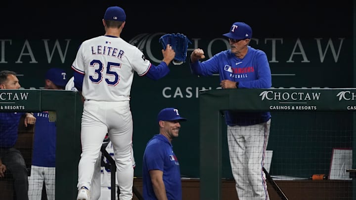 May 13, 2025; Arlington, Texas, USA; Texas Rangers pitcher Jack Leiter (35) bumps fist with pitching coach Mike Maddux (31) as he walks to the dugout after striking out the side during the fourth inning against the Colorado Rockies at Globe Life Field. Mandatory Credit: Raymond Carlin III-Imagn Images