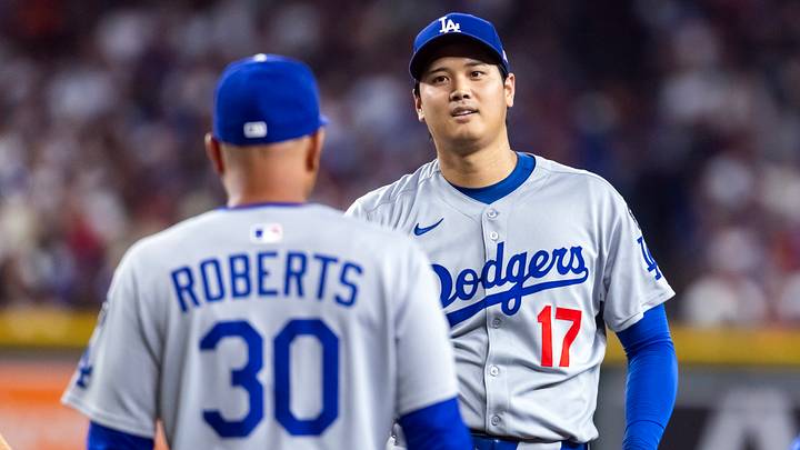 Sep 23, 2025; Phoenix, Arizona, USA; Los Angeles Dodgers pitcher/designated hitter Shohei Ohtani looks at manager Dave Roberts as he walks to the pitchers mound against the Arizona Diamondbacks at Chase Field. Mandatory Credit: Mark J. Rebilas-Imagn Images