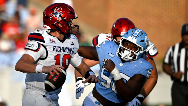 Richmond Spiders quarterback Ashten Snelsire (18) looks to pass as North Carolina Tar Heels defensive lineman Xavier Lewis (90)