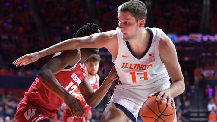 Dec 10, 2024; Champaign, Illinois, USA;  Illinois Fighting Illini center Tomislav Ivisic (13) drives the ball against Wisconsin Badgers forward Xavier Amos (13) during the first half at State Farm Center. Mandatory Credit: Ron Johnson-Imagn Images