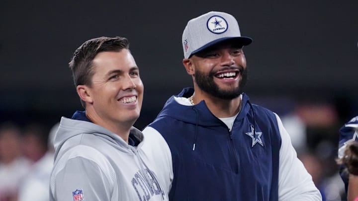 Dallas Cowboys quarterback Dak Prescott uglahs with offensive coordinator Kellen Moore before the game against the New York Giants.