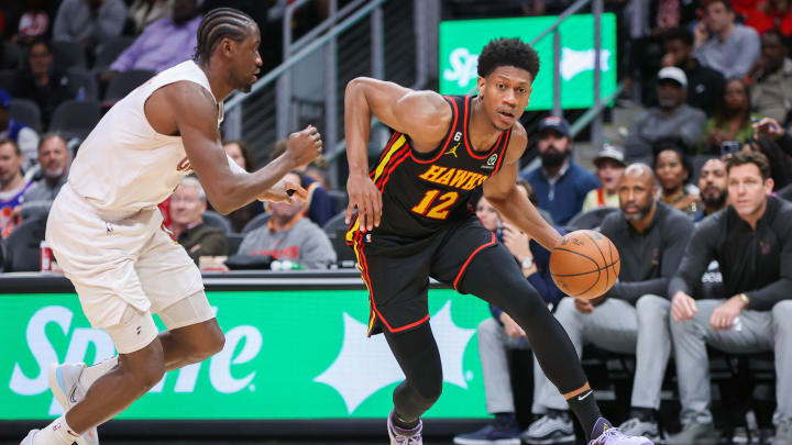 Mar 28, 2023; Atlanta, Georgia, USA; Atlanta Hawks forward De'Andre Hunter (12) drives on Cleveland Cavaliers guard Caris LeVert (3) in the second half at State Farm Arena. Mandatory Credit: Brett Davis-USA TODAY Sports
