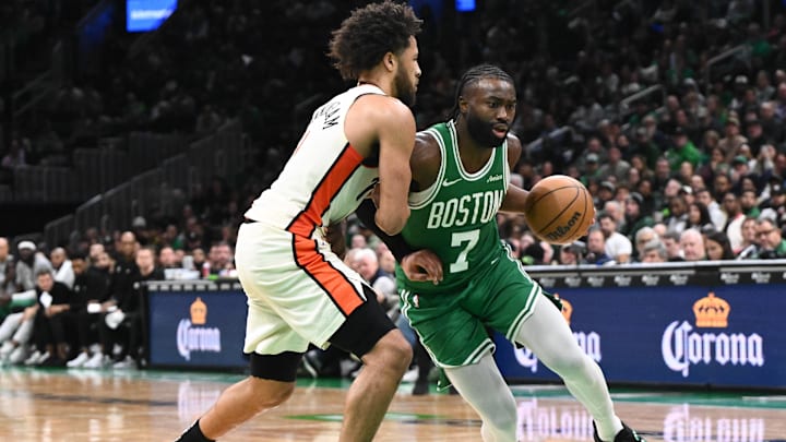 Dec 4, 2024; Boston, Massachusetts, USA; Boston Celtics guard Jaylen Brown (7) drives to the basket against Detroit Pistons guard Cade Cunningham (2) during the fourth quarter at the TD Garden. Mandatory Credit: Brian Fluharty-Imagn Images