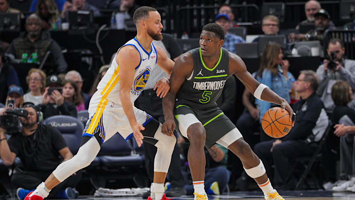Mar 24, 2024; Minneapolis, Minnesota, USA; Golden State Warriors guard Stephen Curry (30) defends Minnesota Timberwolves guard Anthony Edwards (5) in the third quarter at Target Center. Mandatory Credit: Brad Rempel-Imagn Images