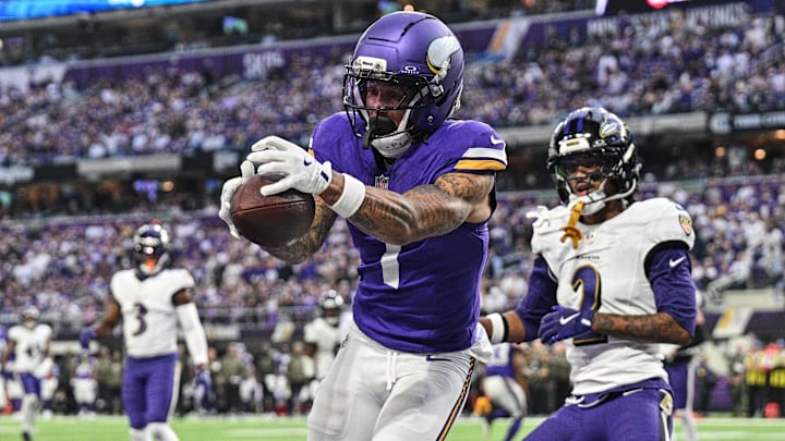 Nov 9, 2025; Minneapolis, Minnesota, USA; Minnesota Vikings wide receiver Jalen Nailor (1) scores on a touchdown pass as Baltimore Ravens cornerback Nate Wiggins (2) defends during the fourth quarter at U.S. Bank Stadium.