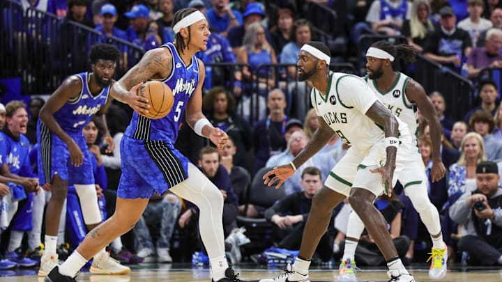 Apr 14, 2024; Orlando, Florida, USA; Milwaukee Bucks forward Bobby Portis (9) defends Orlando Magic forward Paolo Banchero (5) during the second quarter at KIA Center. Mandatory Credit: Mike Watters-Imagn Images