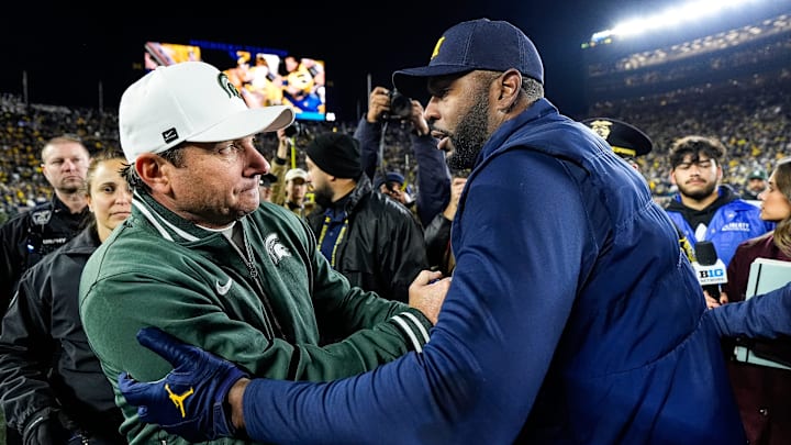 Michigan State head coach Jonathan Smith, left, shakes hands with head coach Sherrone Moore after 24-17 loss at Michigan Stadium in Ann Arbor on Saturday, Oct. 26, 2024.