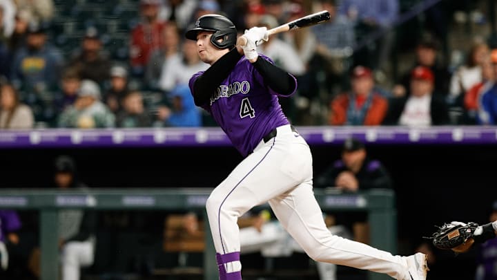 May 19, 2025; Denver, Colorado, USA; Colorado Rockies first baseman Michael Toglia (4) hits a double in the sixth inning against the Philadelphia Phillies at Coors Field. Mandatory Credit: Isaiah J. Downing-Imagn Images