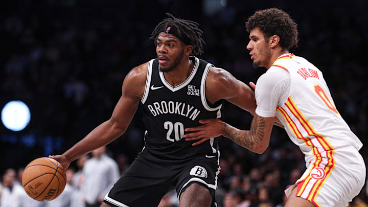Mar 16, 2025; Brooklyn, New York, USA; Brooklyn Nets center Day'Ron Sharpe (20) is defended by Atlanta Hawks forward Dominick Barlow (0) during the second half at Barclays Center. Mandatory Credit: Vincent Carchietta-Imagn Images