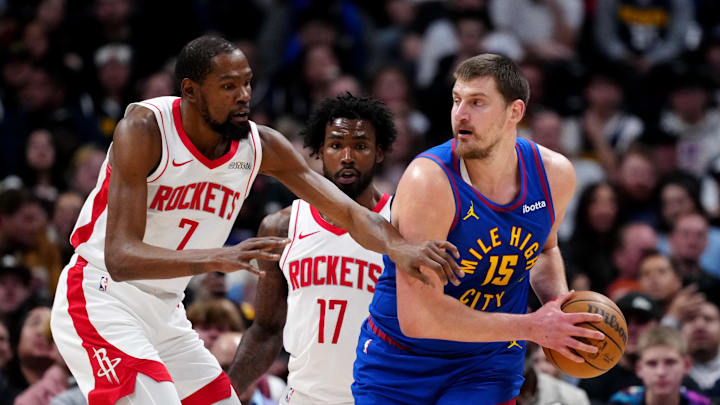 Mar 11, 2026; Denver, Colorado, USA; Houston Rockets forward Kevin Durant (7) defends on Denver Nuggets center Nikola Jokic (15) in the first quarter at Ball Arena. Mandatory Credit: Ron Chenoy-Imagn Images