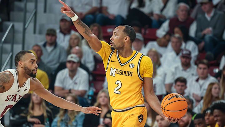 Feb 1, 2025; Starkville, Mississippi, USA; Missouri Tigers guard Tamar Bates (2) looks to pass the ball against Mississippi State Bulldogs guard Claudell Harris Jr. (0) during the second half at Humphrey Coliseum. Mandatory Credit: Wesley Hale-Imagn Images Feb 1, 2025; Starkville, Mississippi, USA; Missouri Tigers guard Tamar Bates (2) looks to pass the ball against Mississippi State Bulldogs guard Claudell Harris Jr. (0) during the second half at Humphrey Coliseum. Mandatory Credit: Wesley Hale-Imagn Images