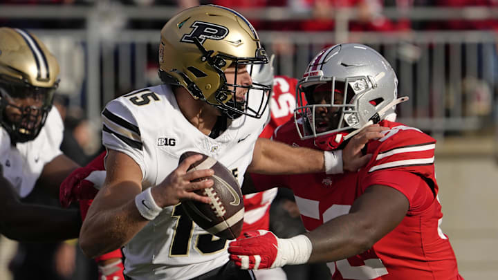 Purdue Boilermakers quarterback Ryan Browne (15) is pursued by Ohio State Buckeyes defensive end Joshua Mickens (52) Purdue Boilermakers quarterback Ryan Browne (15) is pursued by Ohio State Buckeyes defensive end Joshua Mickens (52)