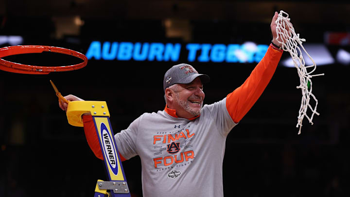 Mar 30, 2025; Atlanta, GA, USA; Auburn Tigers head coach Bruce Pearl cuts down the net after winning the South Regional final of the 2025 NCAA tournament against the Michigan State Spartans at State Farm Arena. Mandatory Credit: Brett Davis-Imagn Images