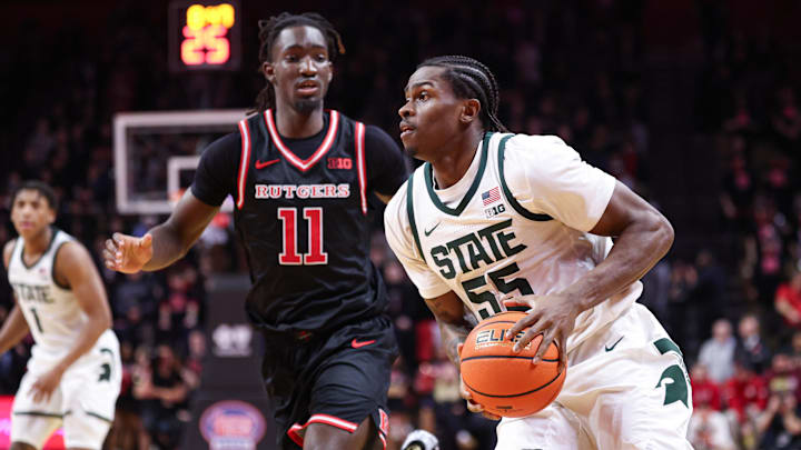 Jan 27, 2026; Piscataway, New Jersey, USA; Michigan State Spartans forward Coen Carr (55) goes to the basket against Rutgers Scarlet Knights forward Christopher Nwuli (11) during the first half at Jersey Mike's Arena. Mandatory Credit: Vincent Carchietta-Imagn Images