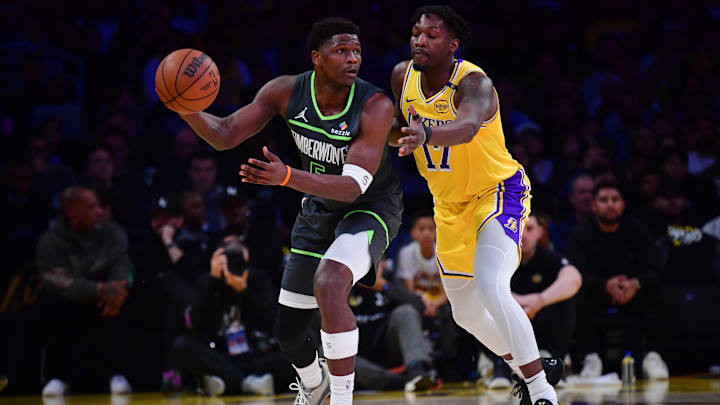 Apr 30, 2025; Los Angeles, California, USA: Minnesota Timberwolves guard Anthony Edwards (5) controls the ball against Los Angeles Lakers forward Dorian Finney-Smith (17) during the first half in game five of first round for the 2025 NBA Playoffs at Crypto.com Arena. Mandatory Credit: Gary A. Vasquez-Imagn Images