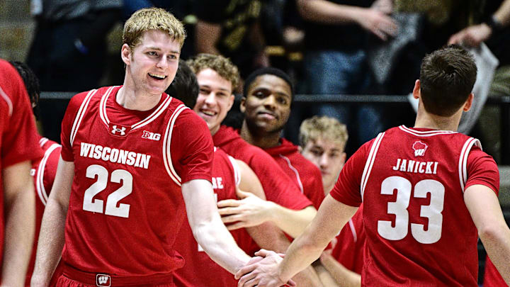 Wisconsin forward Steven Crowl (22) shakes hands with guard Jack Janicki (33) after defeating Purdue 