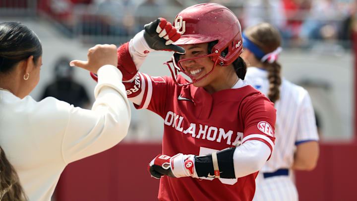 Oklahoma second baseman Ailana Agbayani celebrates after reaching on a single against Kentucky at Love's Field.