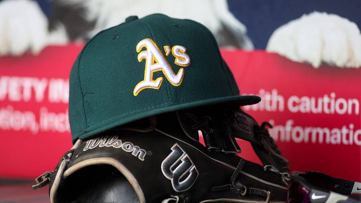 Jun 1, 2024; Atlanta, Georgia, USA; A detailed view of an Oakland Athletics hat and glove on the field against the Atlanta Braves in the sixth inning at Truist Park. Mandatory Credit: Brett Davis-Imagn Images Jun 1, 2024; Atlanta, Georgia, USA; A detailed view of an Oakland Athletics hat and glove on the field against the Atlanta Braves in the sixth inning at Truist Park. Mandatory Credit: Brett Davis-Imagn Images