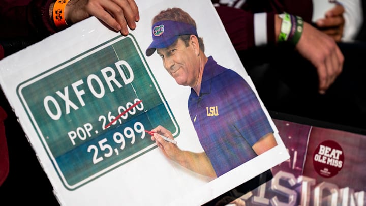 Mississippi State fans hold signs referencing Ole Miss head coach Lane Kiffin’s potential departure during the Egg Bowl.