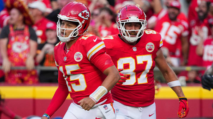 Sep 15, 2024; Kansas City, Missouri, USA; Kansas City Chiefs quarterback Patrick Mahomes (15) and tight end Travis Kelce (87) return to the sidelines after a score against the Cincinnati Bengals during the first half at GEHA Field at Arrowhead Stadium. 