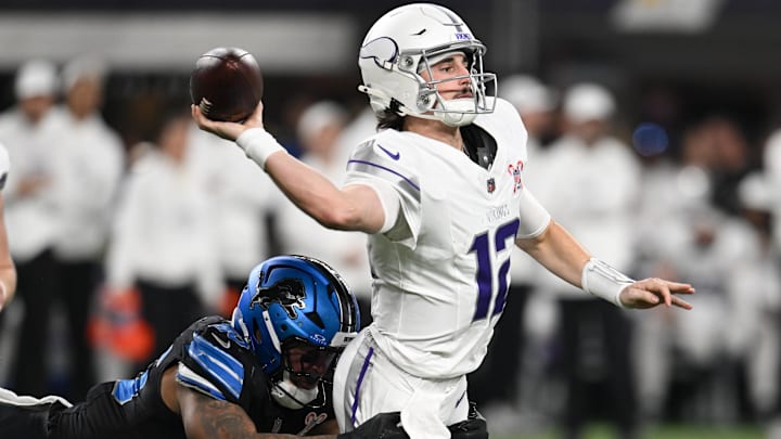 Dec 25, 2025; Minneapolis, Minnesota, USA; Minnesota Vikings quarterback Max Brosmer (12) passes the ball under pressure from Detroit Lions linebacker Derrick Barnes (55) in the second quarter at U.S. Bank Stadium.