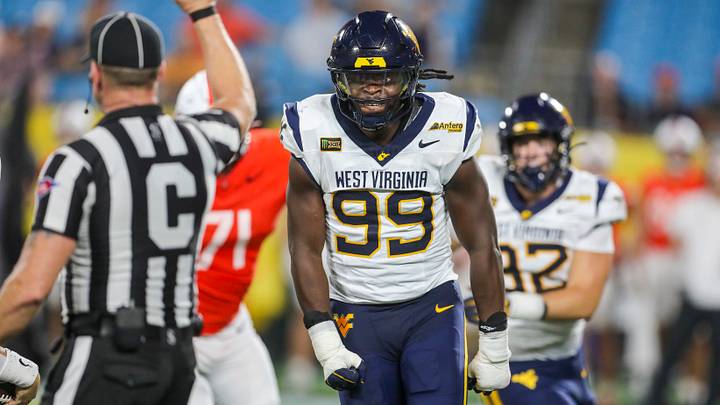 Sep 19, 2026; Charlotte, North Carolina, USA; West Virginia Mountaineers defensive end David Afogho (99) celebrates after sacking Virginia Cavaliers quarterback Beau Pribula (7) during the second quarter at Bank of America Stadium. Mandatory Credit: Ben Queen-Imagn Images
