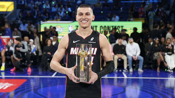Miami Heat guard Tyler Herro celebrates with the trophy after winning the NBA three-point contest.