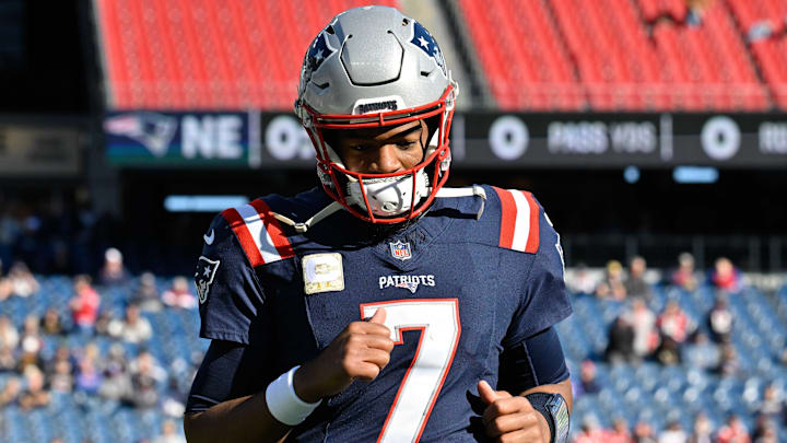Nov 17, 2024; Foxborough, Massachusetts, USA; New England Patriots quarterback Jacoby Brissett (7) warms up before a game against the Los Angeles Rams at Gillette Stadium. Mandatory Credit: Eric Canha-Imagn Images