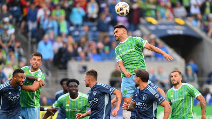 Sep 15, 2024; Seattle, Washington, USA; Seattle Sounders midfielder Cristian Roldan (7) heads the ball in the second half against the Sporting Kansas City at Lumen Field. Mandatory Credit: Steven Bisig-Imagn Images