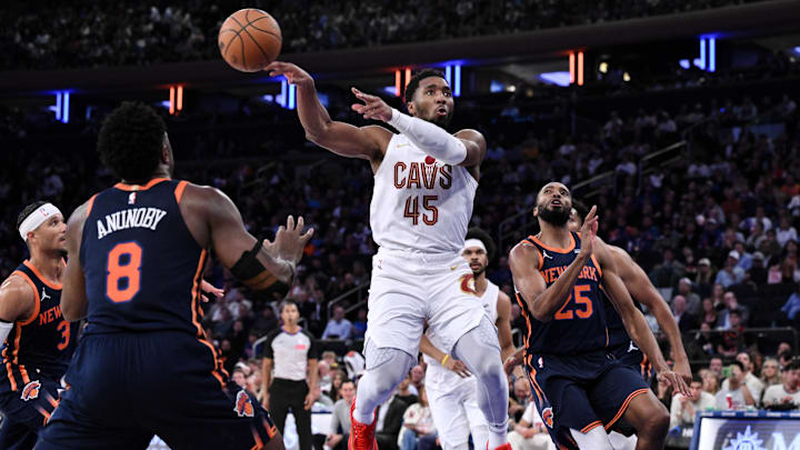 Oct 28, 2024; New York, New York, USA; Cleveland Cavaliers guard Donovan Mitchell (45) passes the ball as New York Knicks forward OG Anunoby (8) and New York Knicks forward Mikal Bridges (25) defend during the second half at Madison Square Garden. Mandatory Credit: John Jones-Imagn Images