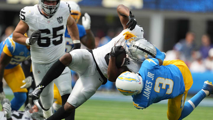 Sep 8, 2024; Inglewood, California, USA; Las Vegas Raiders running back Zamir White (left) is tackled by Los Angeles Chargers safety Derwin James Jr (3) in the second half at SoFi Stadium. Mandatory Credit: Kirby Lee-Imagn Images