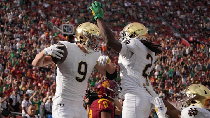Nov 30, 2024; Los Angeles, California, USA; Notre Dame Fighting Irish tight end Eli Raridon (9) celebrates with wide receiver Jayden Harrison (2) after catching a 12 yard touchdown pass against the Southern California Trojans in the first half at United Airlines Field at Los Angeles Memorial Coliseum. Mandatory Credit: Kirby Lee-Imagn Images
