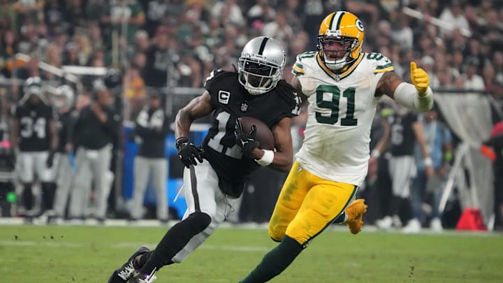 Las Vegas Raiders receiver Davante Adams is pursued by Green Bay Packers defender Preston Smith during last year's game in Las Vegas.