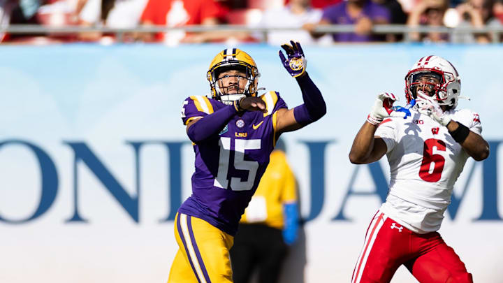 Jan 1, 2024; Tampa, FL, USA; LSU Tigers safety Sage Ryan (15) attempts to breakup a pass to Wisconsin Badgers wide receiver Will Pauling (6) during the first half at Raymond James Stadium. Mandatory Credit: Matt Pendleton-Imagn Images