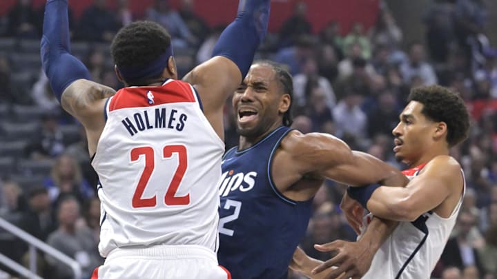 Mar 1, 2024; Los Angeles, California, USA; Los Angeles Clippers forward Kawhi Leonard (2) is defended by Washington Wizards forward Richaun Holmes (22) as he is fouled by guard Jordan Poole (13) in the first half at Crypto.com Arena. Mandatory Credit: Jayne Kamin-Oncea-Imagn Images