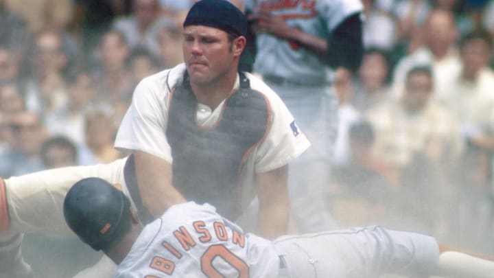Jun 1969; Detroit, MI, USA; FILE PHOTO; Detroit Tigers catcher BILL FREEHAN in a play at the plate against Baltimore Orioles outfielder FRANK ROBINSON at Tiger Stadium during the 1969 season. 
