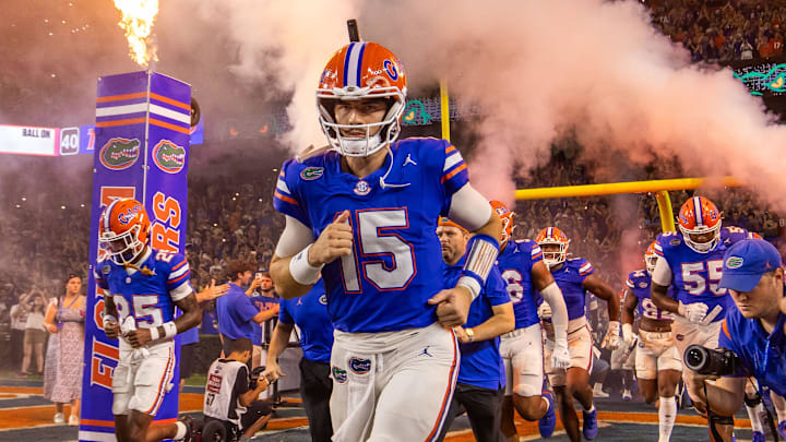 Florida Gators quarterback Graham Mertz (15) runs out of the tunnel with the team as fireworks and fire shoot out of towers before the start of the game at Ben Hill Griffin Stadium in Gainesville, FL on Saturday, October 5, 2024. [Doug Engle/Gainesville Sun]