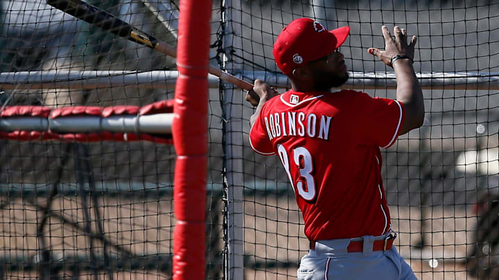 Cincinnati Reds minor league catcher Chuckie Robinson (83) takes batting practice. Cincinnati Reds minor league catcher Chuckie Robinson (83) takes batting practice.
