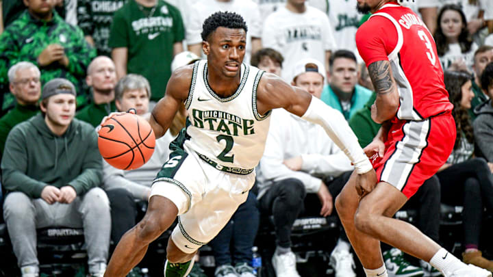 Michigan State's Tyson Walker, left, moves past Ohio State's Taison Chatman during the first half on