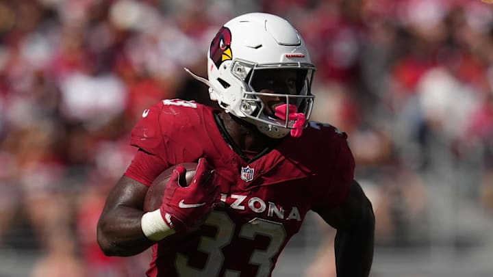 Sep 21, 2025; Santa Clara, California, USA; Arizona Cardinals running back Trey Benson (33) carries the ball against the San Francisco 49ers during the second half at Levi's Stadium. Mandatory Credit: Cary Edmondson-Imagn Images
