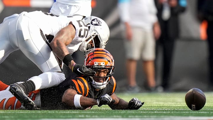 Cincinnati Bengals wide receiver Ja'Marr Chase (1) is pulled down away from the ball by Las Vegas Raiders cornerback Decamerion Richardson (25) on a pass in the third quarter of the NFL Week 9 game between the Cincinnati Bengals and the Las Vegas Raiders at Paycor Stadium in downtown Cincinnati on Sunday, Nov. 3, 2024. The Bengals collected their first win at home with a 41-24 victory over the Raiders.