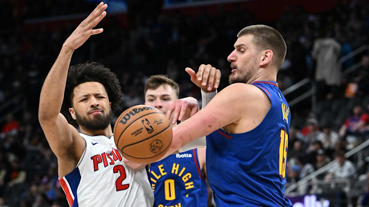 Feb 28, 2025; Detroit, Michigan, USA; Detroit Pistons guard Cade Cunningham (2) gets fouled by Denver Nuggets center Nikola Jokic (15) in the third quarter at Little Caesars Arena. Mandatory Credit: Lon Horwedel-Imagn Images