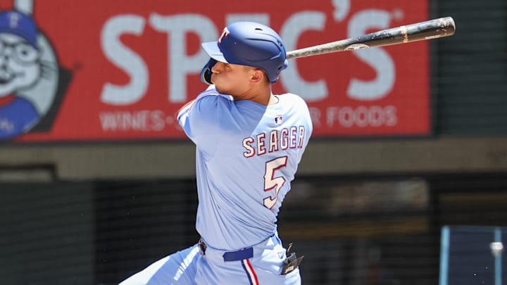 May 4, 2025; Arlington, Texas, USA;  Texas Rangers shortstop Corey Seager (5) hits a two-run single during the third inning against the Seattle Mariners at Globe Life Field. 