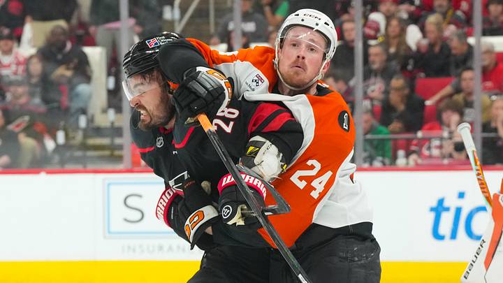 May 4, 2026; Raleigh, North Carolina, USA; Philadelphia Flyers defenseman Nick Seeler (24) and Carolina Hurricanes left wing William Carrier (28) battle in front of the net during the third period in game two of the second round of the 2026 Stanley Cup Playoffs at Lenovo Center.