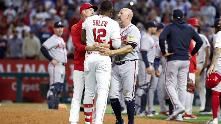 Apr 7, 2026; Anaheim, California, USA; Los Angeles Angels right fielder Jorge Soler (12) speaks with coaching staff after a fight breaks out with Atlanta Braves pitcher Reynaldo López (40) during the fifth inning at Angel Stadium. Mandatory Credit: William Navarro-Imagn Images