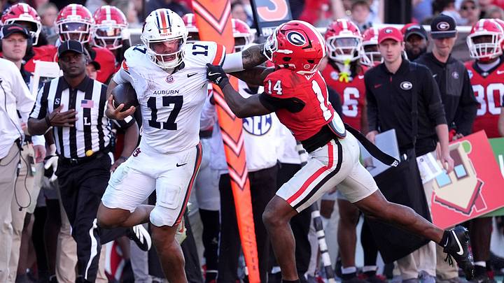 Auburn quarterback Byrum Brown runs for a gain past Georgia safety Rasean Dinkins. Auburn quarterback Byrum Brown runs for a gain past Georgia safety Rasean Dinkins.