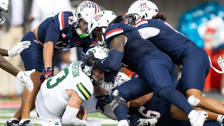 Nov 22, 2025; Tucson, Arizona, USA; Baylor Bears quarterback Sawyer Robertson (13) is tackled by the Arizona Wildcats in the first half at Casino Del Sol Stadium. Mandatory Credit: Mark J. Rebilas-Imagn Images