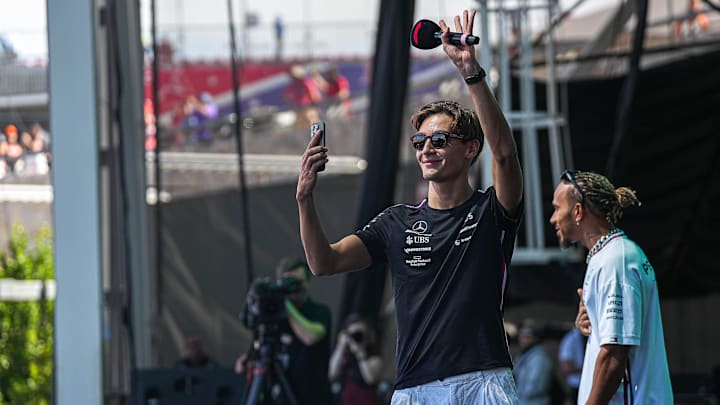 Mercedes AMG Petronas driver George Russell takes video of the crowd during driver engagements in